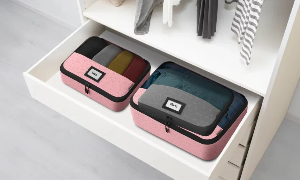 Packing cubes used as laundry sorters in a home closet.