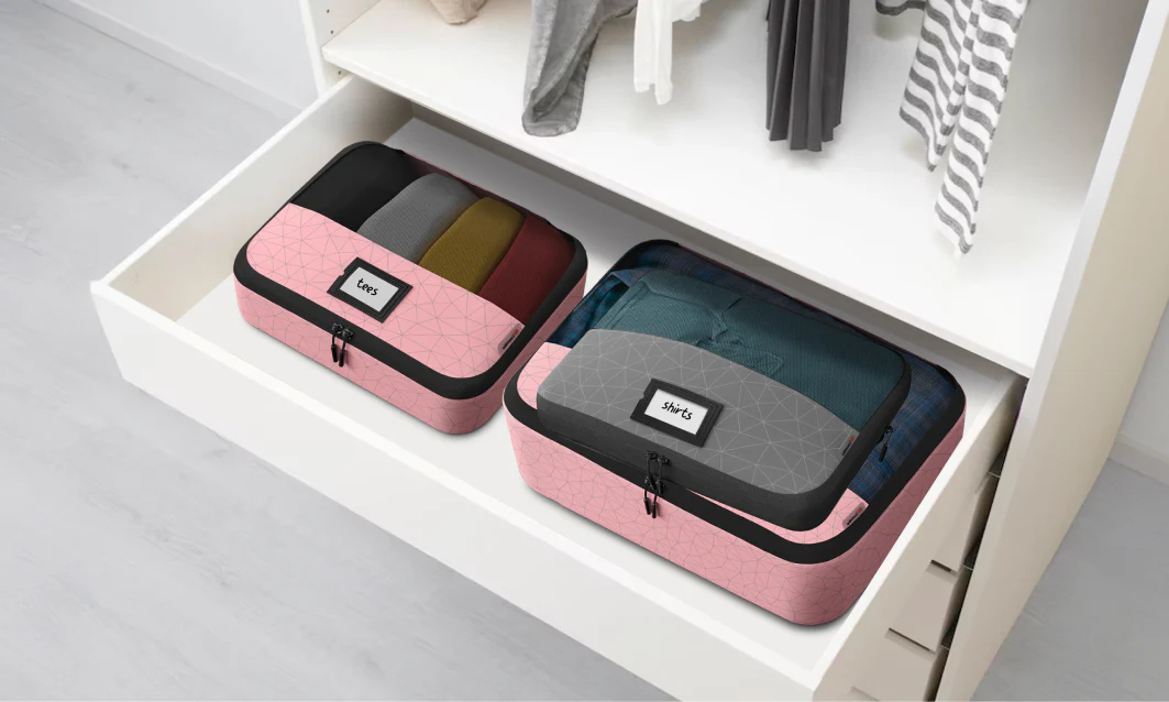 Packing cubes used as laundry sorters in a home closet.