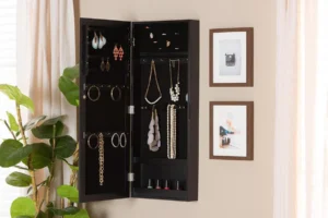 Wall-mounted jewelry cabinet with mirror and organized jewelry inside.
