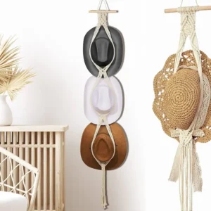Boho macramé hat organizer hanging on white bedroom wall