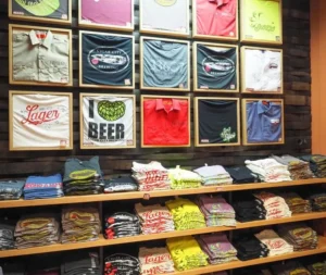 Graphic T-shirts displayed on a pegboard wall as storage and decoration