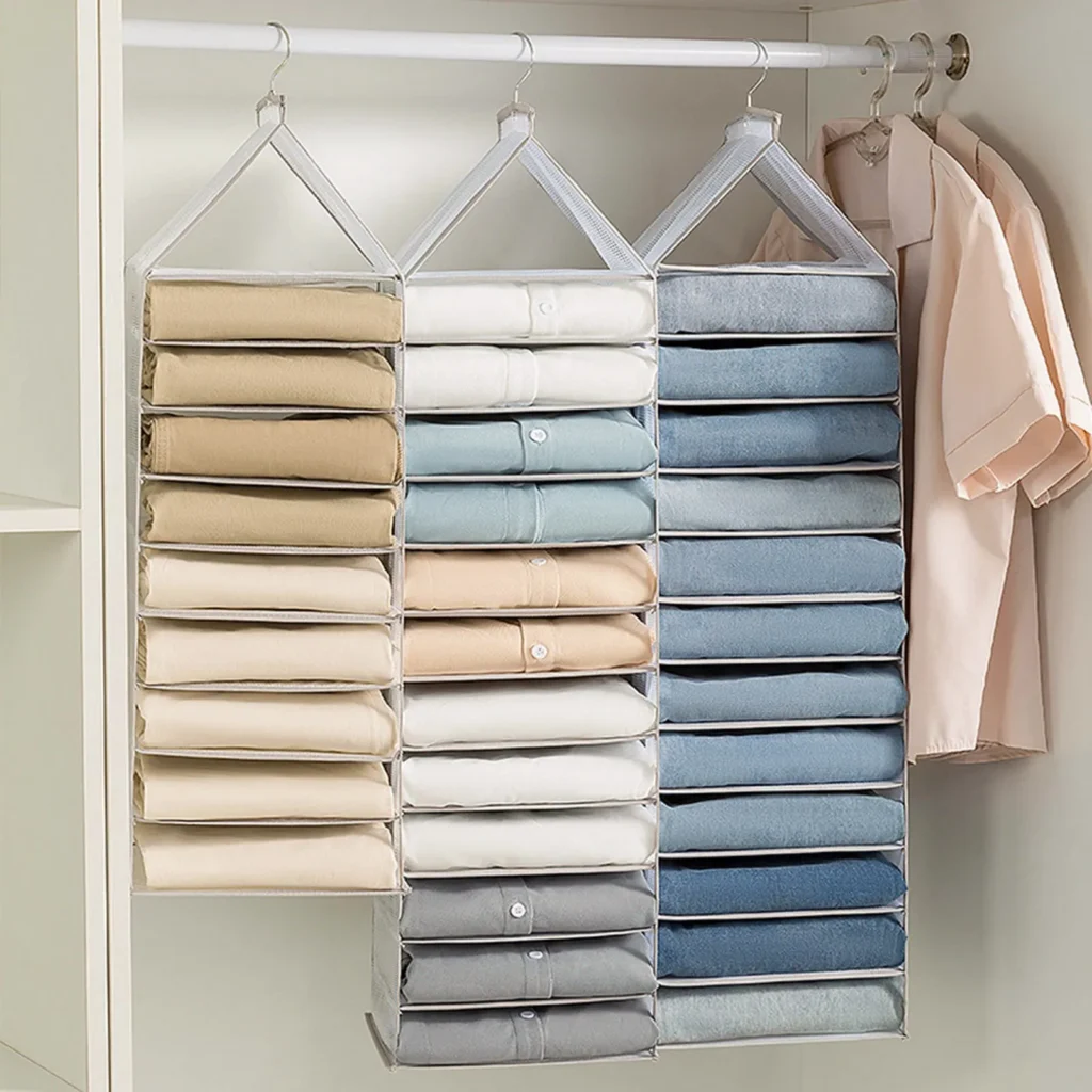 Hanging sweater organizer with neatly folded knits in a closet