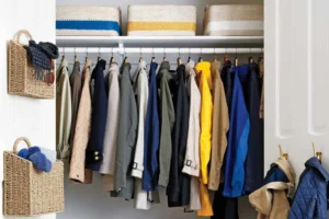 Neatly organized coat closet with slim black hangers and winter coats