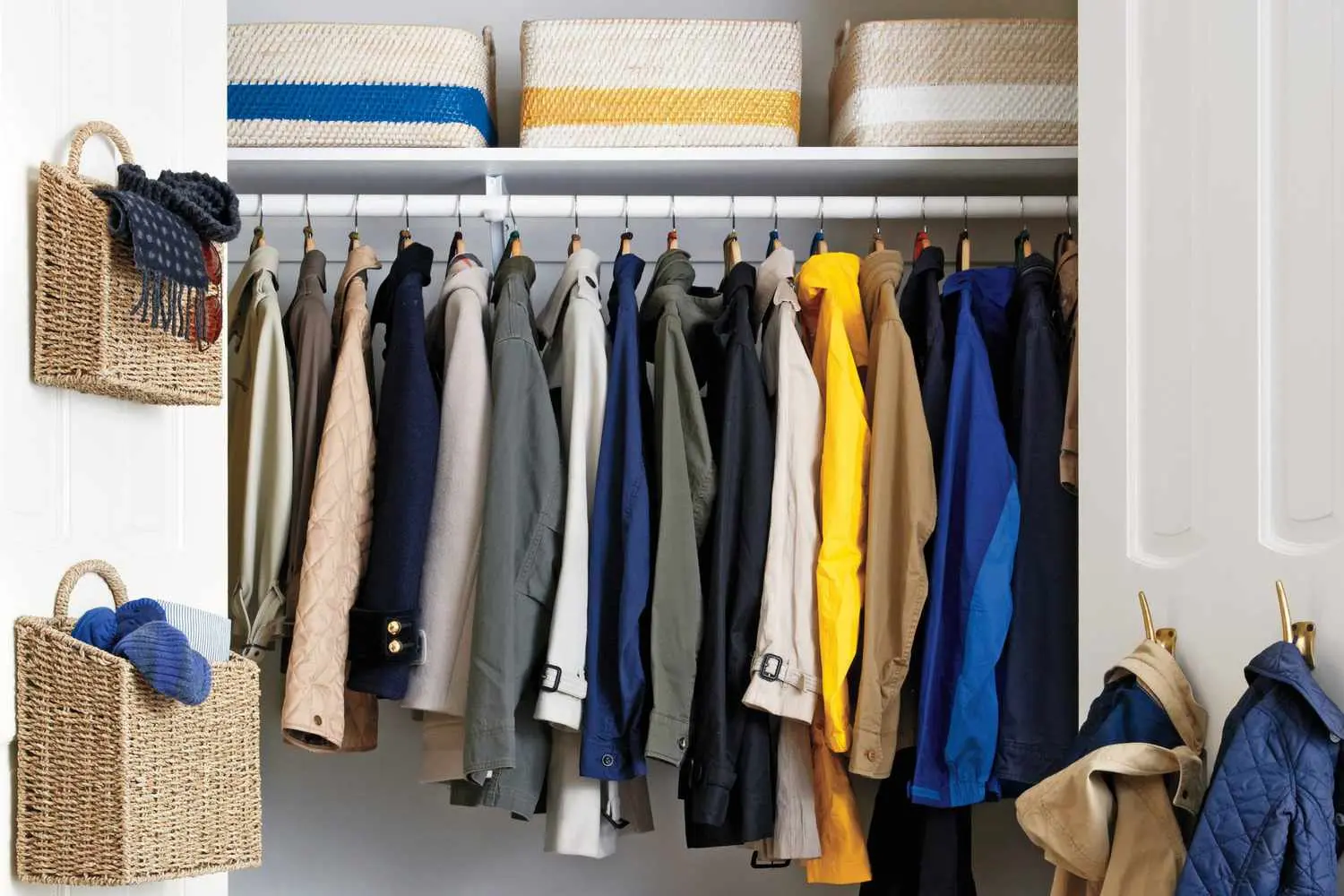 Neatly organized coat closet with slim black hangers and winter coats