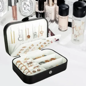 Open travel jewelry organizer box with organized rings and necklaces