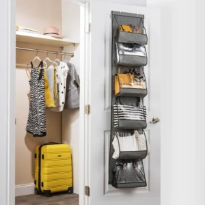 Over-the-door transparent handbag organizer with visible pockets holding various purses