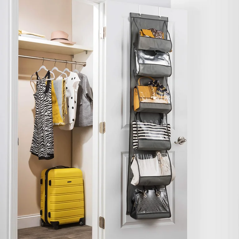 Over-the-door transparent handbag organizer with visible pockets holding various purses