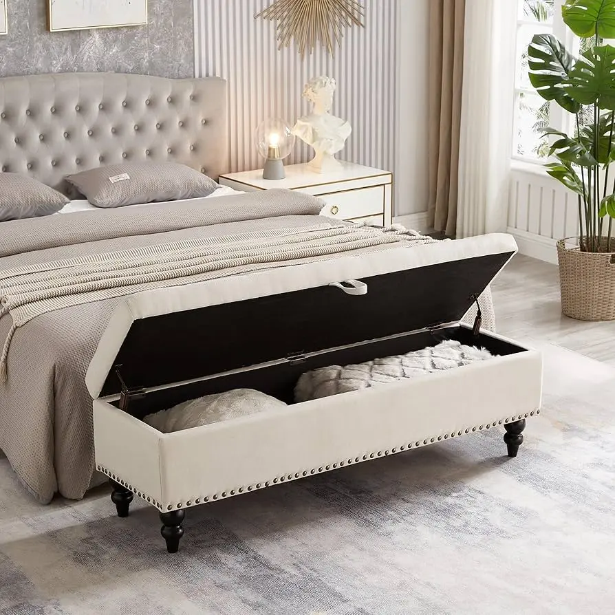 Tufted upholstered storage bench at the end of a king-sized bed
