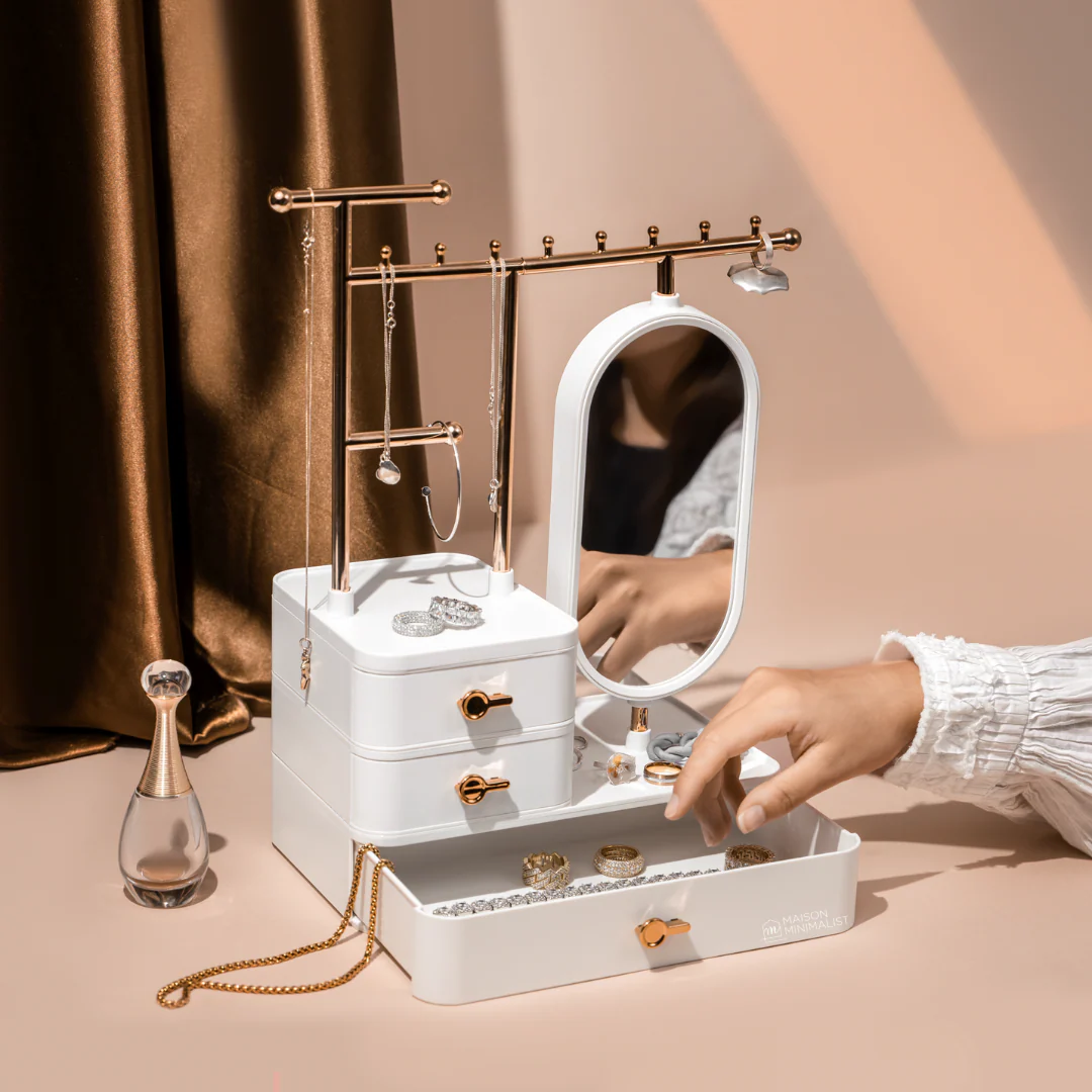 Minimalist jewelry tray on vanity with rings, perfume, and mirror