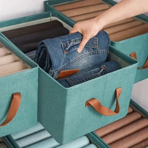 Neatly folded clothes stored in a twill fabric storage box to prevent mold