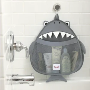 Shark-shaped bath toy organizer hanging from bathtub faucet