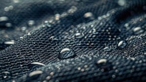 Close-up of waterproof fabric showing water droplets beading on the surface