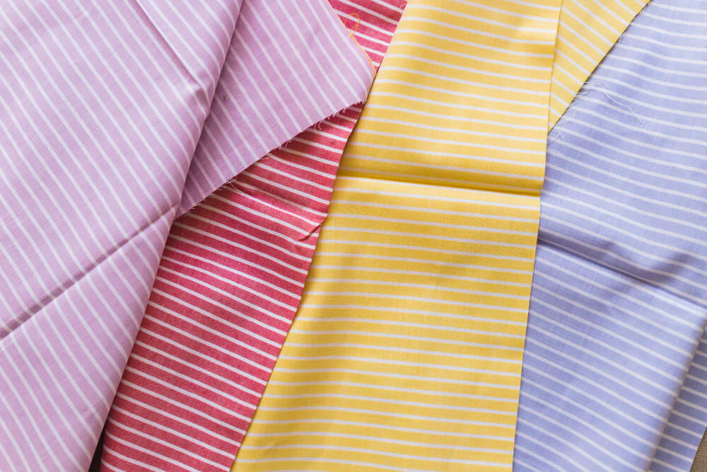 Close-up texture of poplin fabric showing plain weave pattern