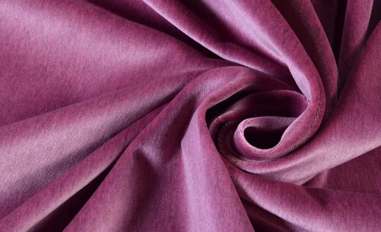 Close-up texture of velvet fabric showing soft pile weave