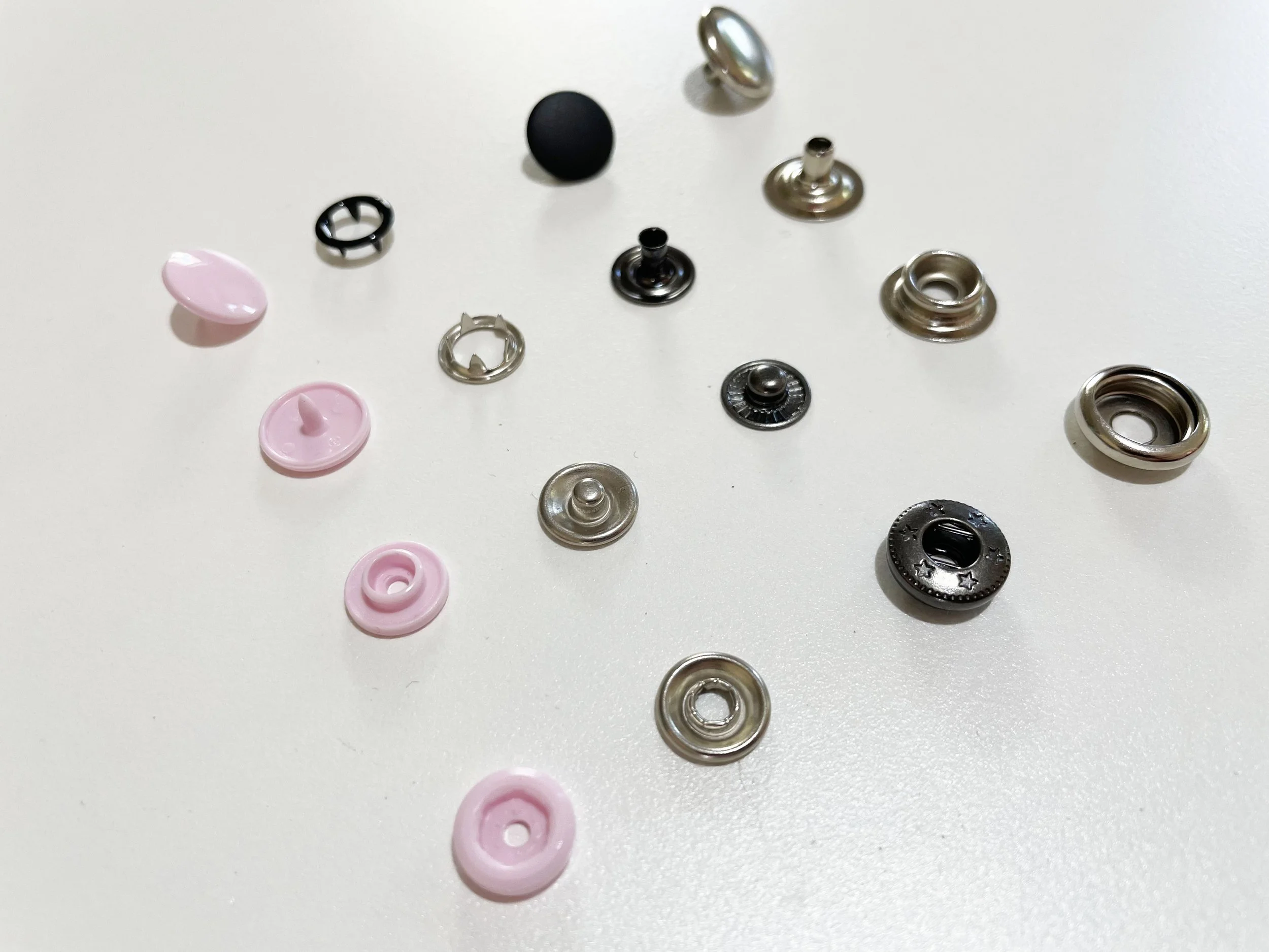 Different types of fabric snaps including metal, plastic, and sew-on options