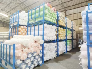 Polyester fabric rolls in warehouse ready for large-scale textile production