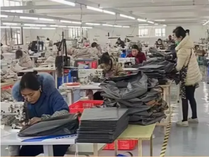 Fabric being sewn into storage boxes and travel organizers in workshop